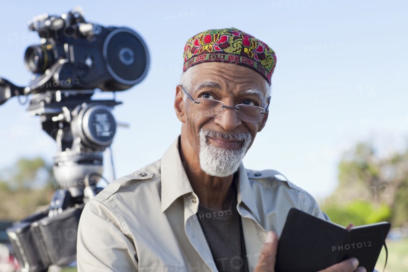 African American director near film camera