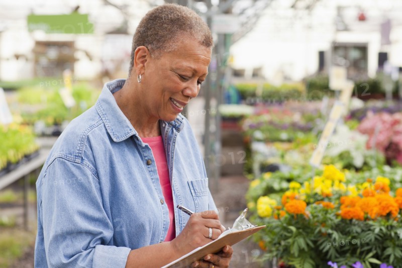 Mixed race woman working in plant nursery