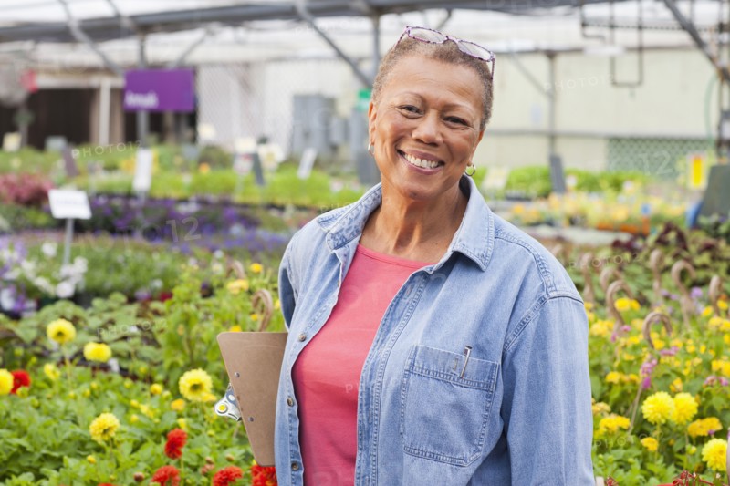 Mixed race woman working in plant nursery