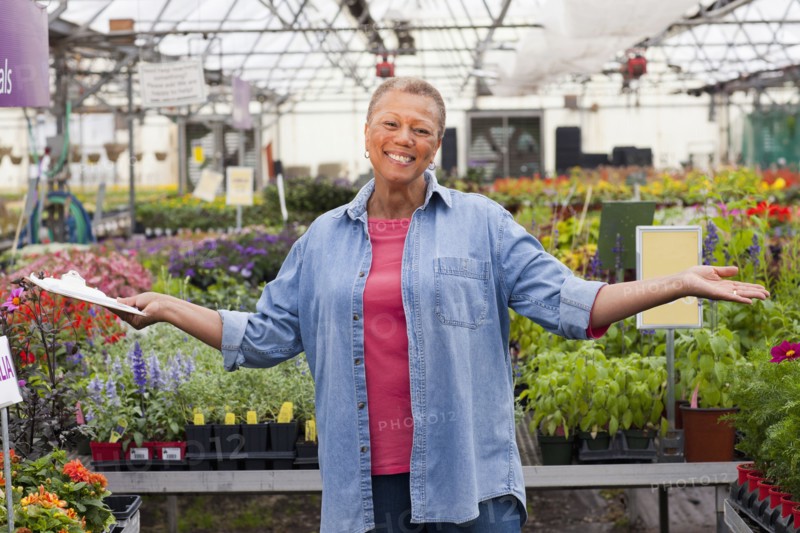 Mixed race woman working in plant nursery