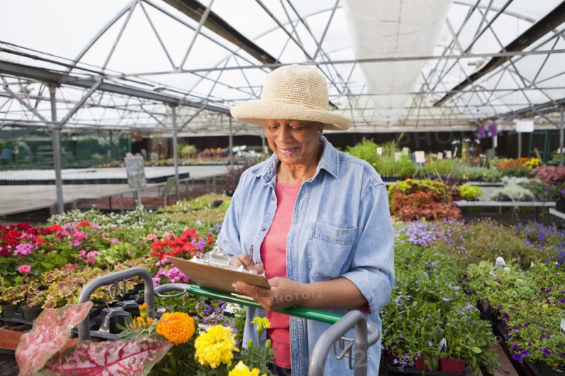 Mixed race woman working in plant nursery