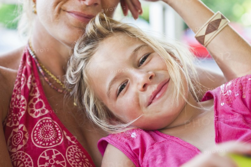 Caucasian mother and daughter sitting together
