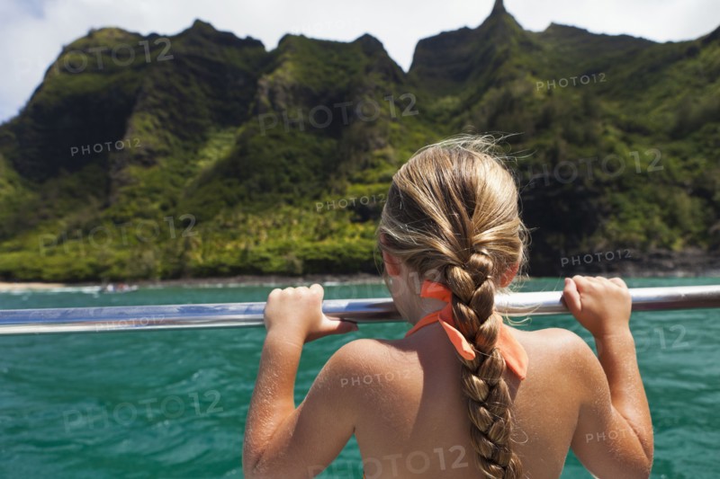 Caucasian girl on boat looking at ocean