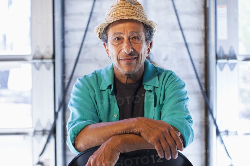 Older Caucasian man sitting in chair