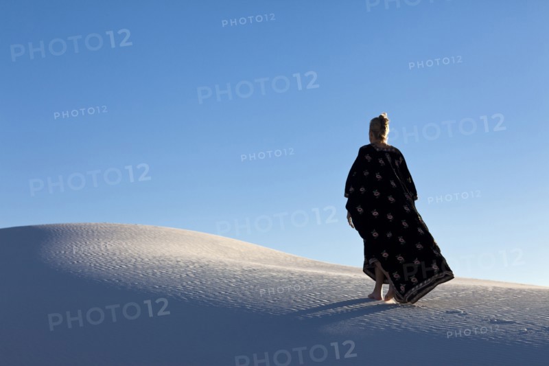 Caucasian woman walking in desert