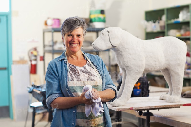 Caucasian sculptor working in studio