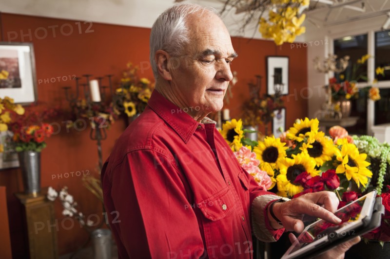 Caucasian florist using tablet computer in shop