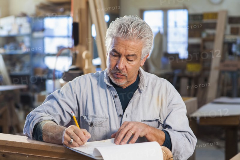 Hispanic craftsman working in studio