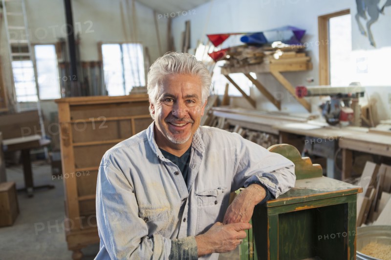 Hispanic craftsman smiling in studio