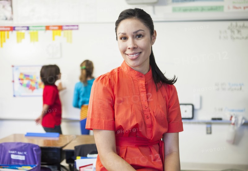 Mixed race teacher smiling in classroom