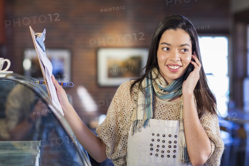 Mixed race woman working in coffee shop