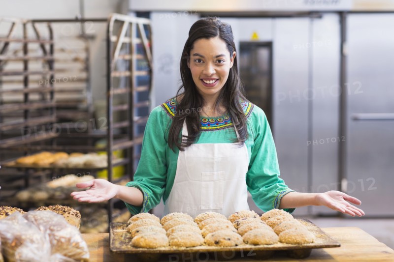 Mixed race woman baking in industrial kitchen