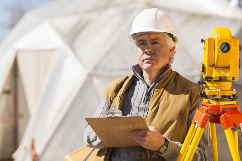 Hispanic surveyor working outdoors