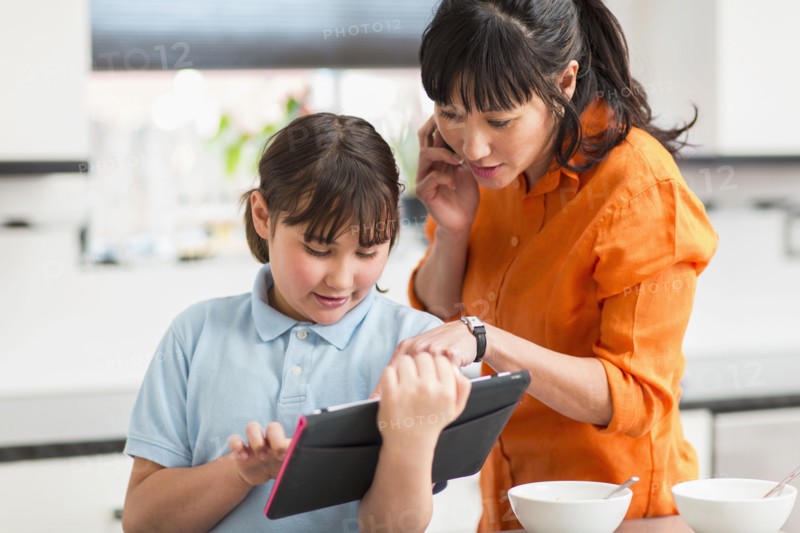 Mother and daughter using tablet computer