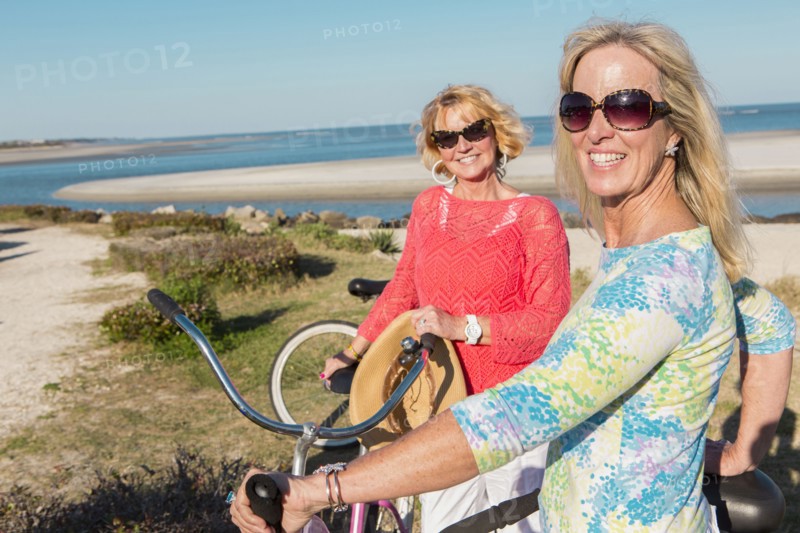 Caucasian women riding bicycles together