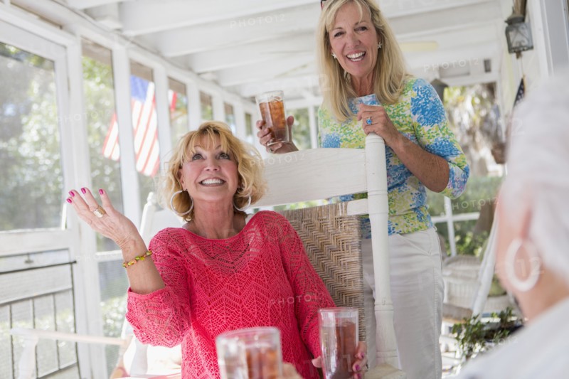 Caucasian women talking on porch