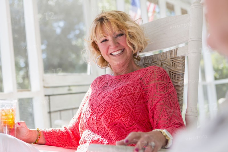 Caucasian woman smiling on porch