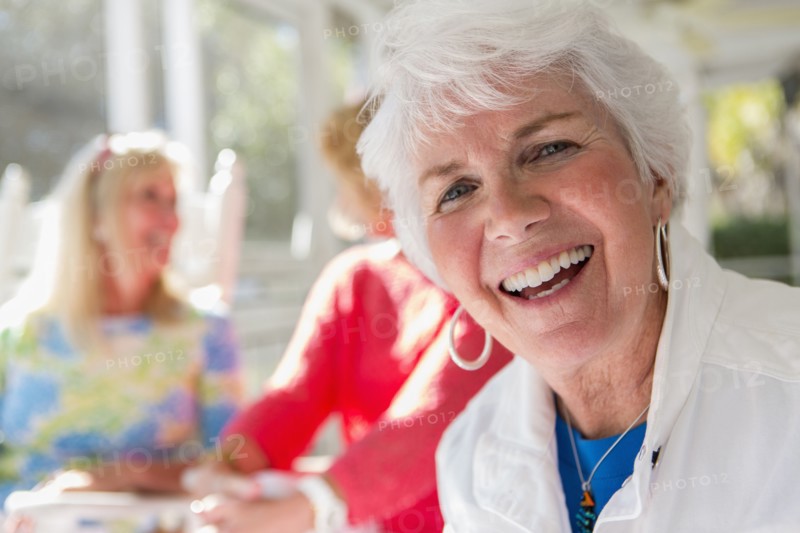 Caucasian woman smiling on porch