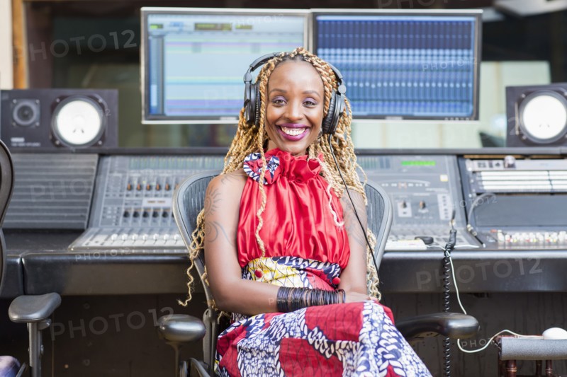 African American singer listening to track in studio