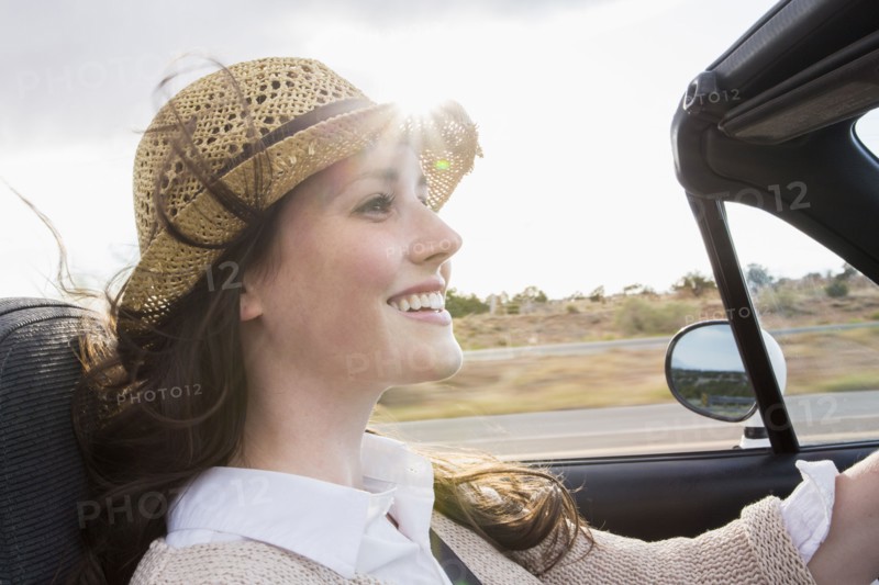 Caucasian woman driving convertible