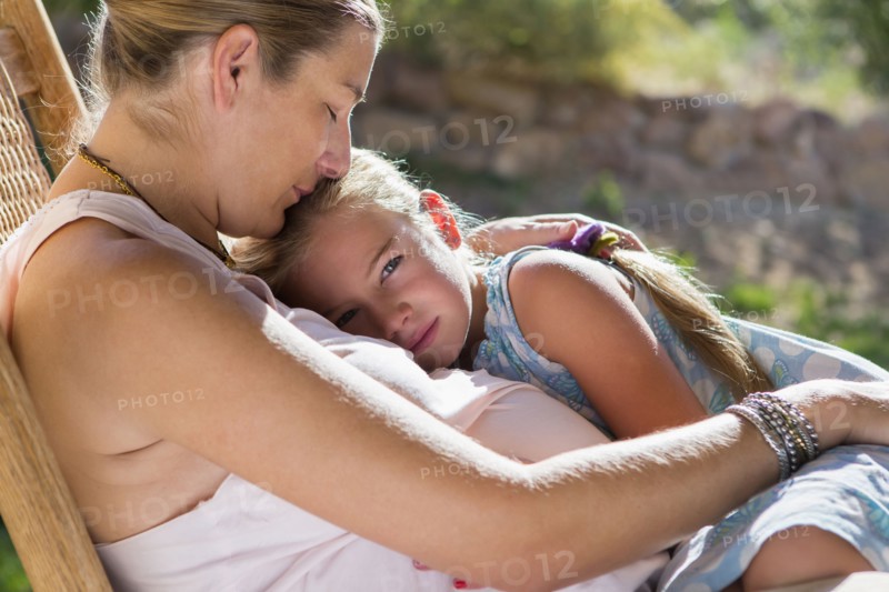 Caucasian mother and daughter relaxing outdoors