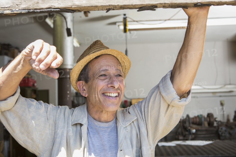 Middle Eastern man smiling in workshop