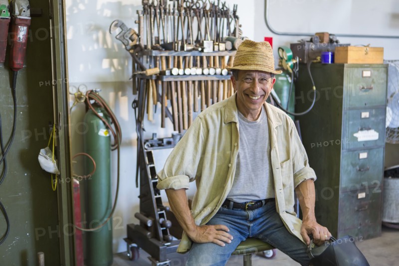Middle Eastern man smiling in workshop