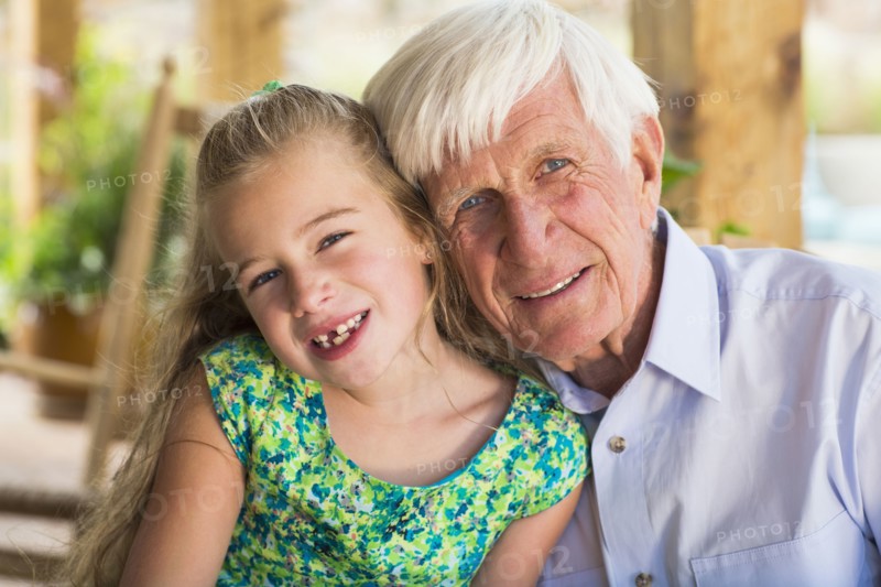 Caucasian man and granddaughter smiling
