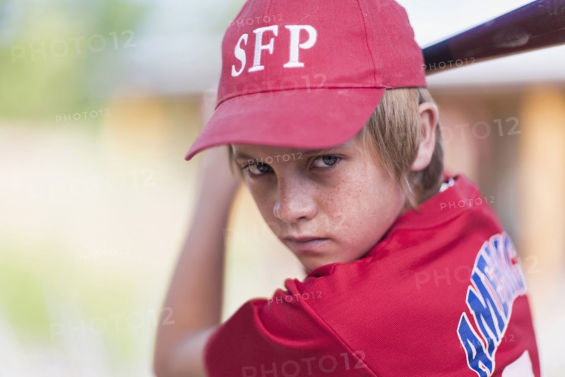 Caucasian boy playing baseball outdoors
