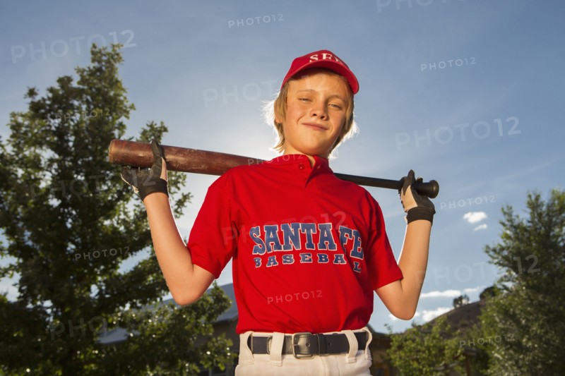Caucasian boy playing baseball outdoors