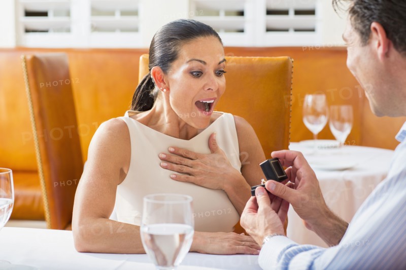 Man proposing to girlfriend at restaurant