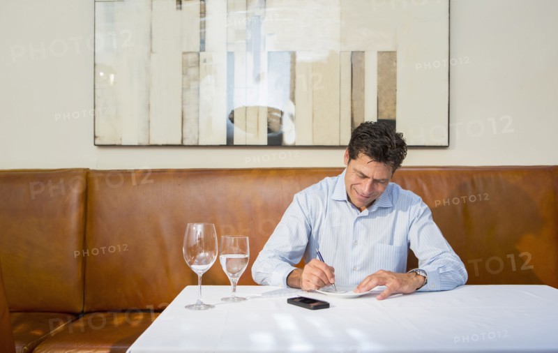 Caucasian businessman working at restaurant