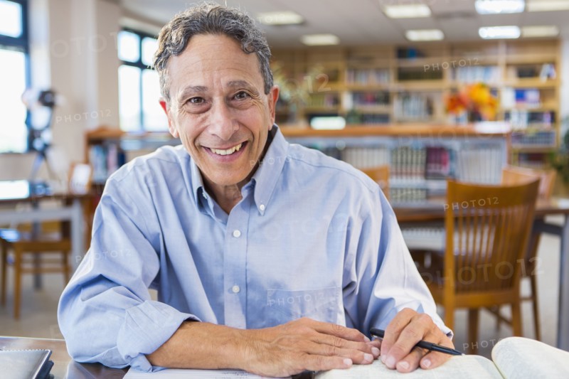 Senior man working in library