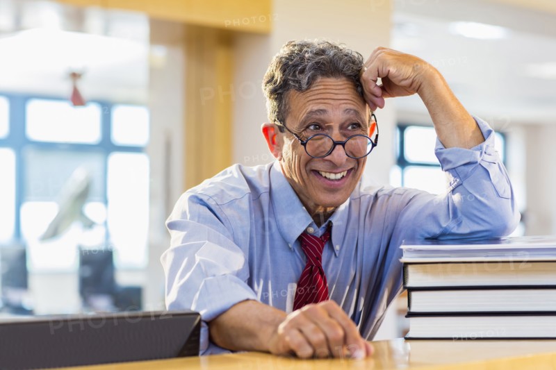 Senior man smiling in library