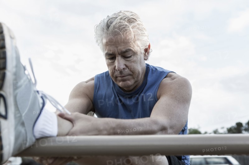 Hispanic man stretching outdoors