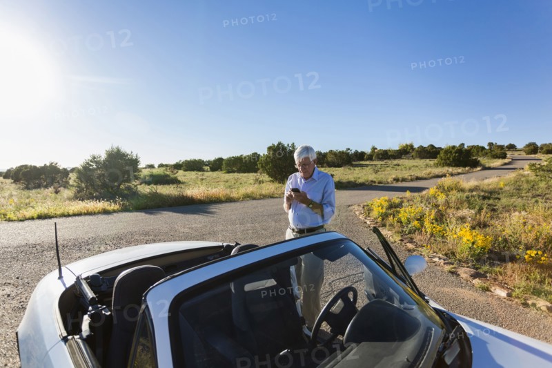 Senior Caucasian man walking to convertible