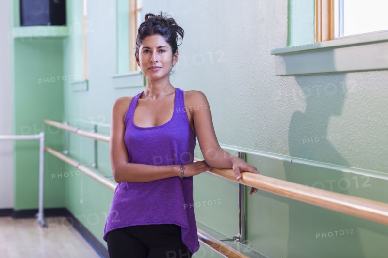 Ballet teacher standing at barre in studio