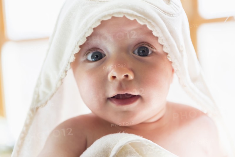 Caucasian baby wrapped in towel