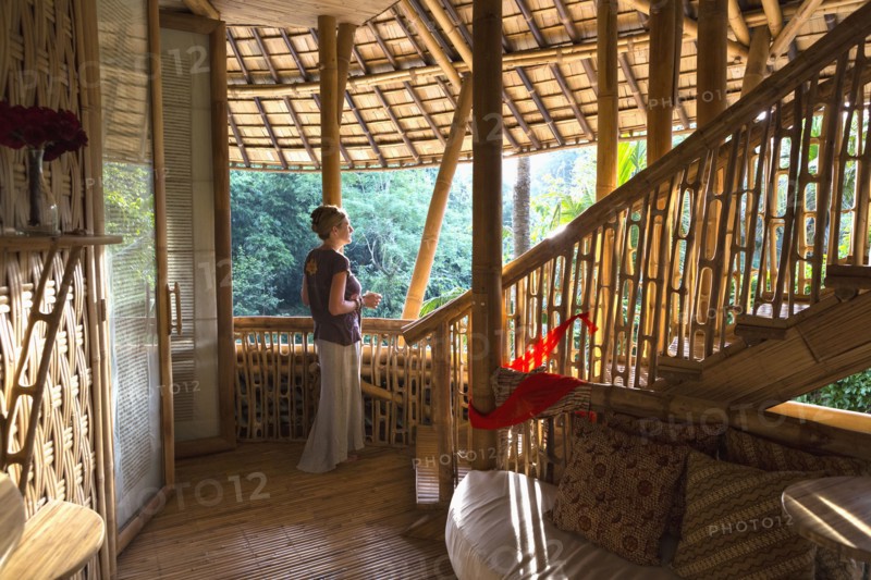 Caucasian woman standing in bamboo room