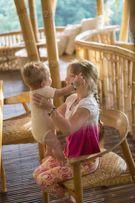 Caucasian girl holding baby boy