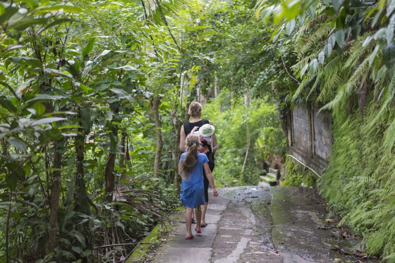 Caucasian family walking in tropical garden