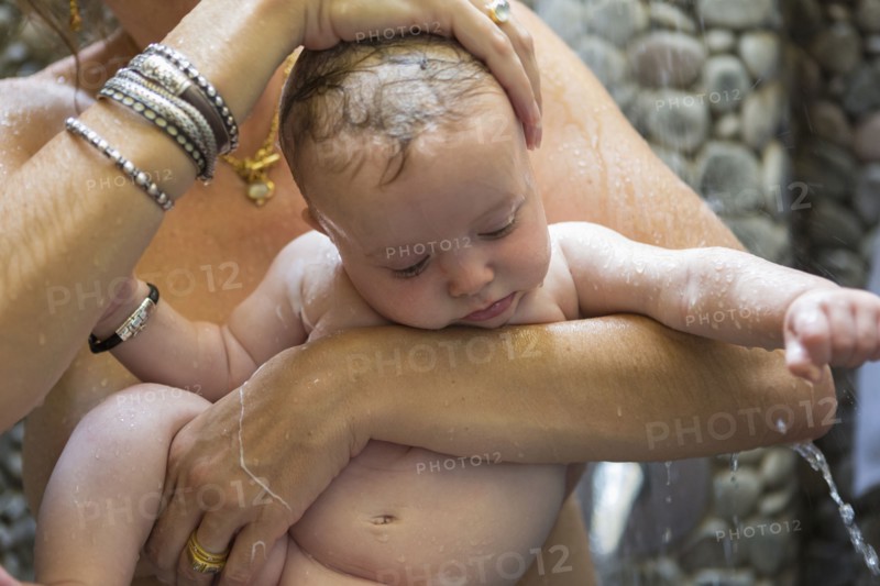 Caucasian mother and baby taking shower
