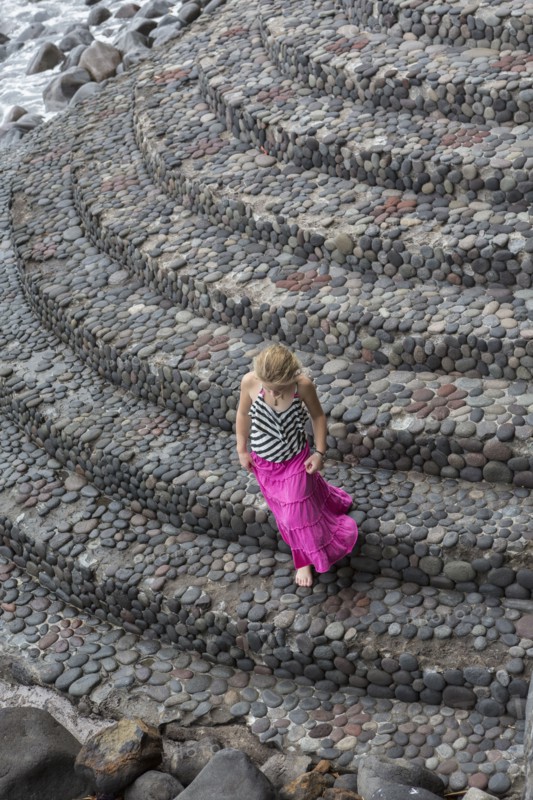 Caucasian girl climbing cobblestone steps
