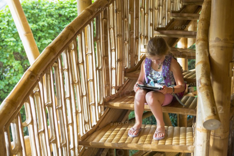 Caucasian girl reading on steps