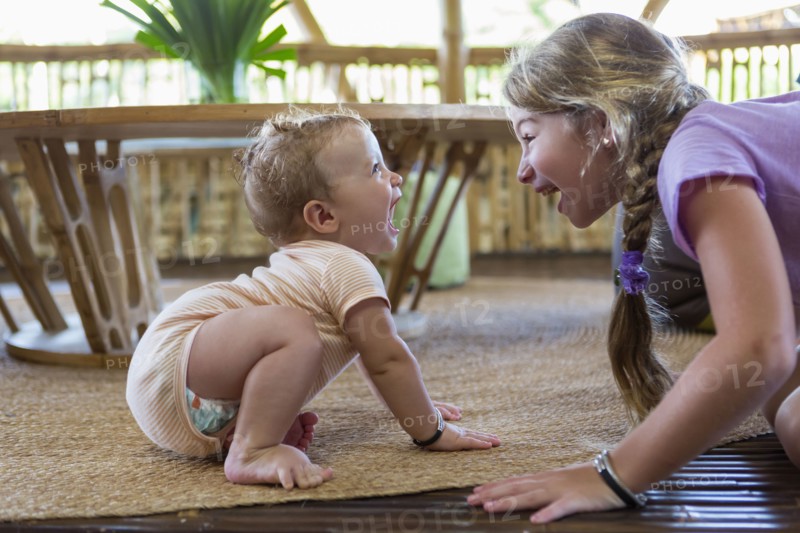 Caucasian children playing on floor