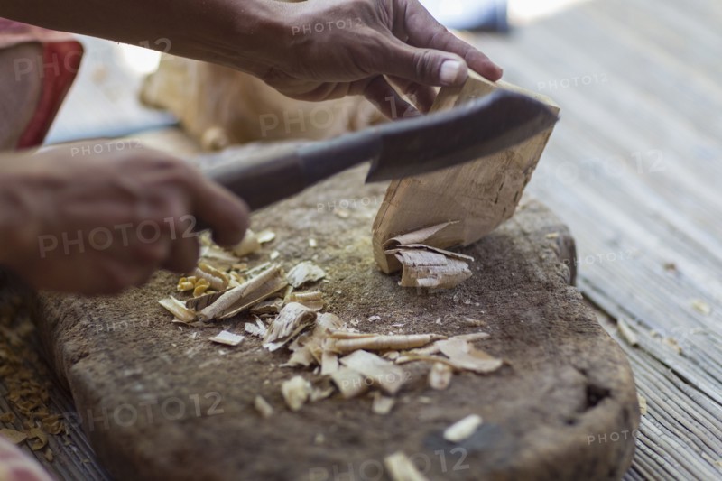 Wood worker chiseling piece in studio