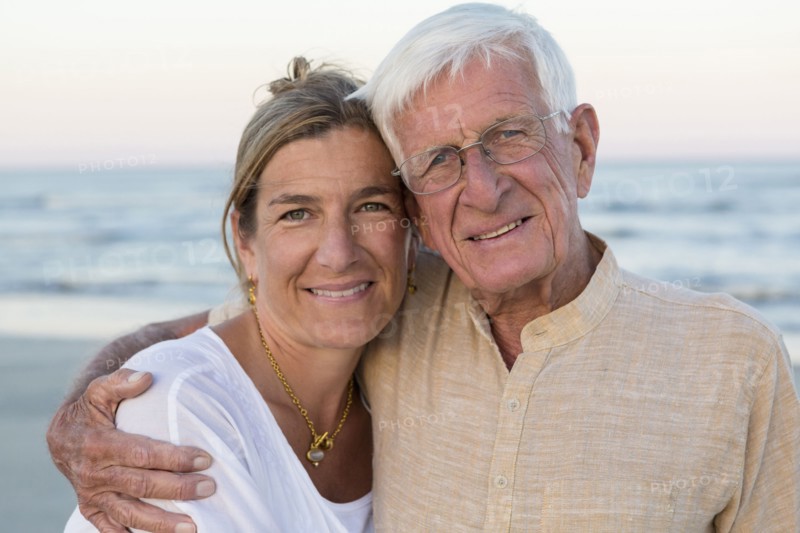 Caucasian father and daughter smiling on beach