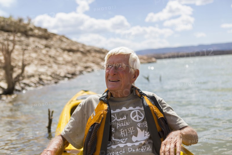 Older Caucasian man rowing on lake