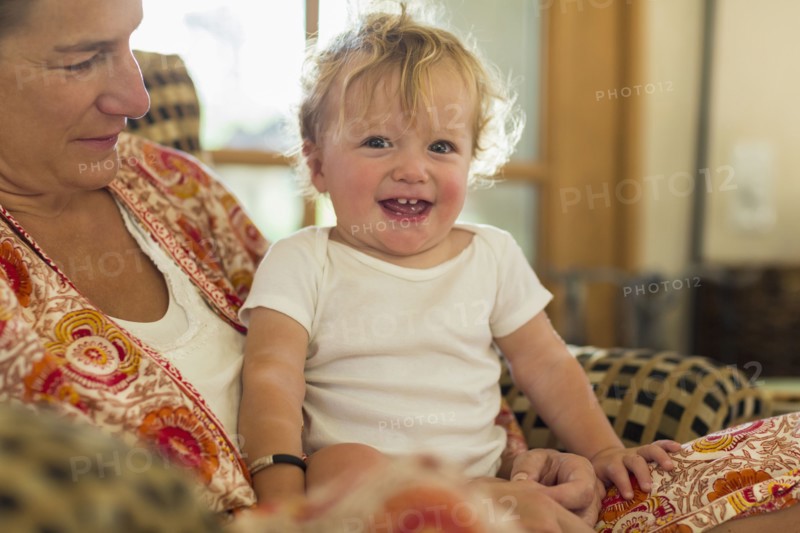 Caucasian mother holding toddler in living room
