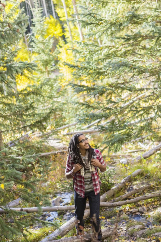 Mixed race man hiking in forest